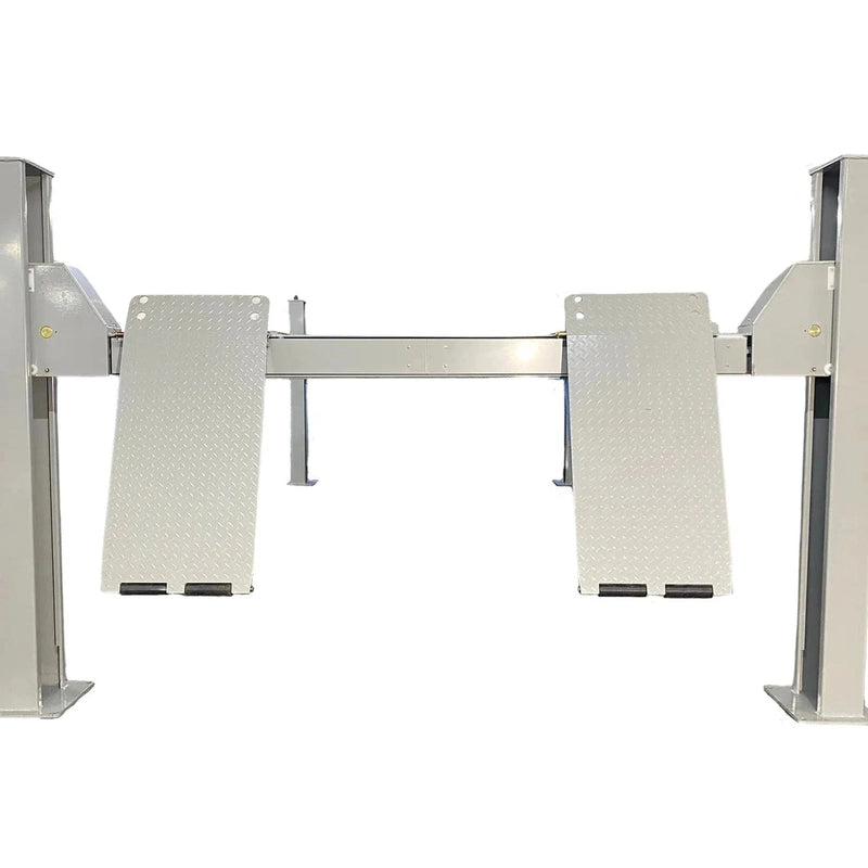 Front view of the four-post lift with diamond-plate approach ramps in stowed position