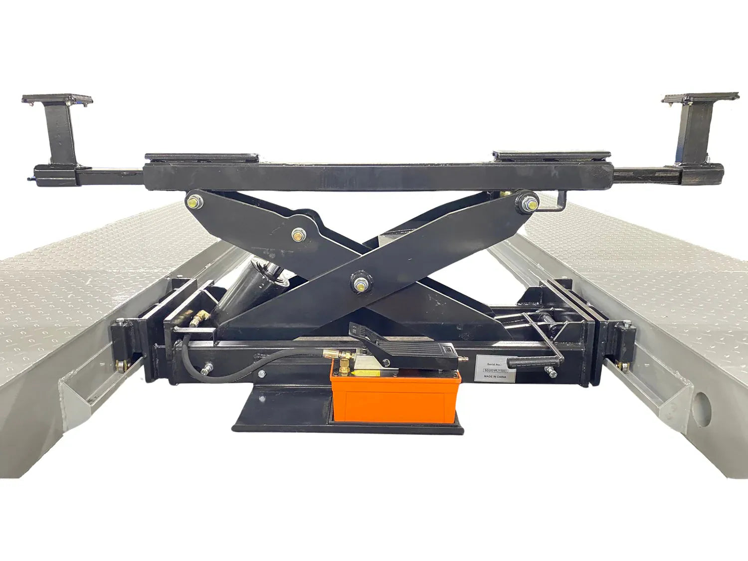 Rolling bridge jack mounted between the four-post lift runways with scissor mechanism partially extended