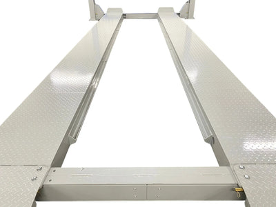 Triumph NTR-32 four-post lift top-down view along the diamond-plate runways and rolling-jack rail channels