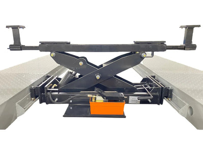 Triumph RJ-9000 rolling bridge jack extended on four-post lift runways with scissor mechanism at full height