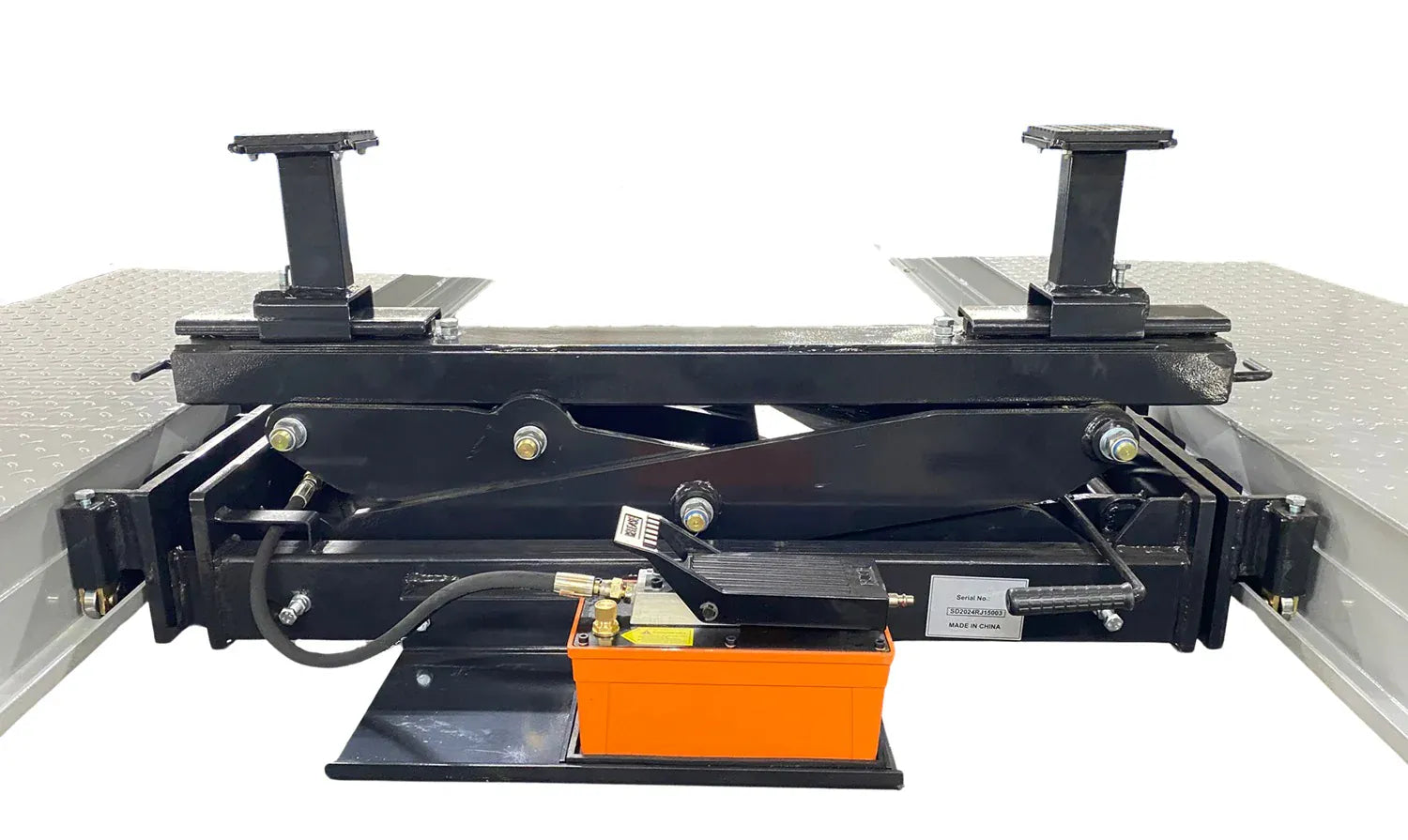 Triumph RJ-9000 rolling bridge jack at lowered position between four-post lift runways with orange foot-pump visible