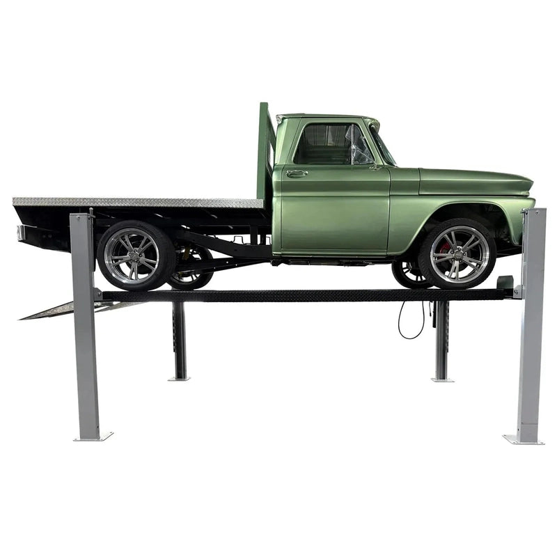 Triumph USA8000 four-post lift raised with a green pickup truck, full side profile