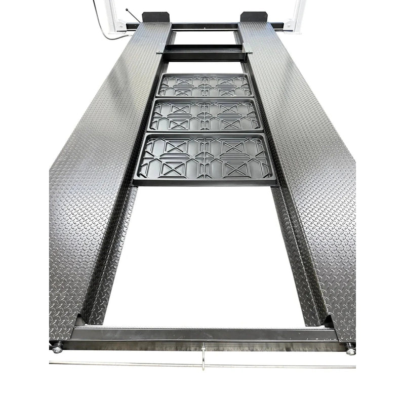 Top-down close-up of the center channel with three drip trays and the jack-tray slot between the runways