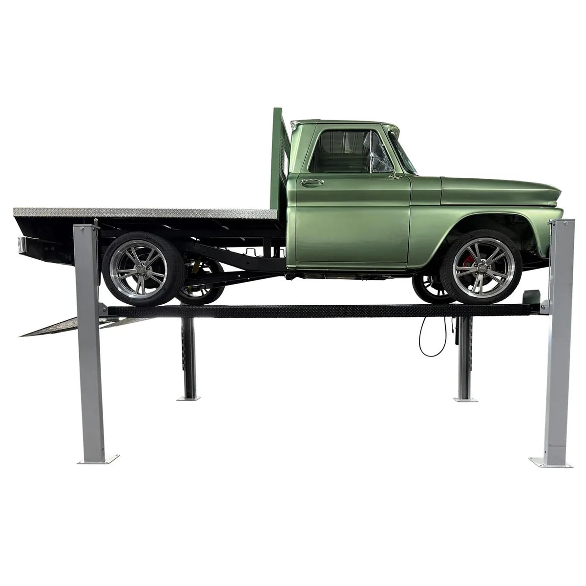 Side profile of the USA8000XLT four-post lift raised with a green classic Chevrolet flatbed pickup